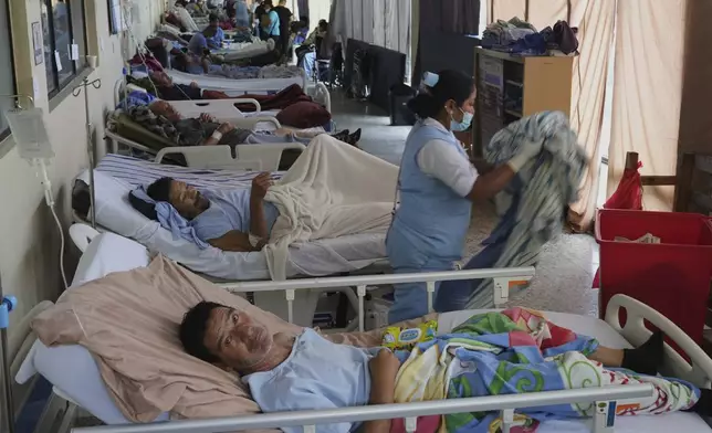 Patients are gathered in a safe area of "Hermano Pedro" Hospital after being relocated from other areas of the hospital in Antigua, Guatemala, Wednesday, July 9, 2025, following dozens of earthquakes and aftershocks were recorded in a matter of hours. (AP Photo/Moises Castillo)