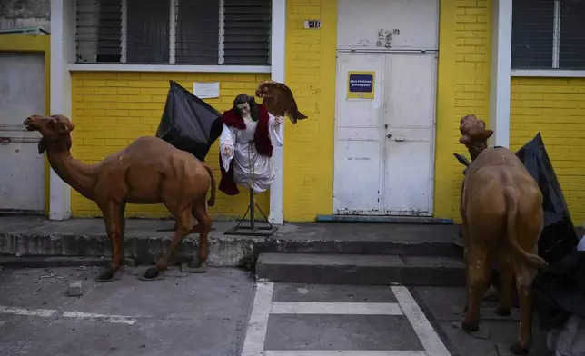 Religious statues sit outside, near a Catholic church that was damaged in Palin, Guatemala, Wednesday, July 9, 2025, after dozens of earthquakes and aftershocks were recorded in a matter of hours. (AP Photo/Moises Castillo)