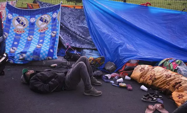 Neighbors remain outside their home in Palin, Guatemala, Wednesday, July 9, 2025, After a series of earthquakes with magnitudes ranging from 3.0 to 5.6, according to authorities. (AP Photo/Moises Castillo)