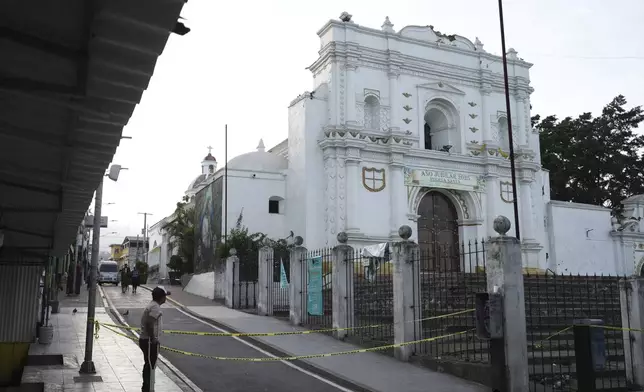 A man stands next to the Catholic Church that was damaged in Palin, Guatemala, Wednesday, July 9, 2025, After a series of earthquakes with magnitudes ranging from 3.0 to 5.6, according to authorities. (AP Photo/Moises Castillo)