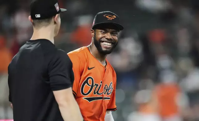 Baltimore Orioles' Cedric Mullins, right, celebrates after his team's victory over the Colorado Rockies in a baseball game, Saturday, July 26, 2025, in Baltimore. (AP Photo/Stephanie Scarbrough)