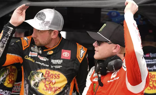 Chase Briscoe, left, and Ty Gibbs watch during qualifications for the NASCAR Cup Series auto race at Indianapolis Motor Speedway, Saturday, July 26, 2025, in Indianapolis. (AP Photo/Darron Cummings)