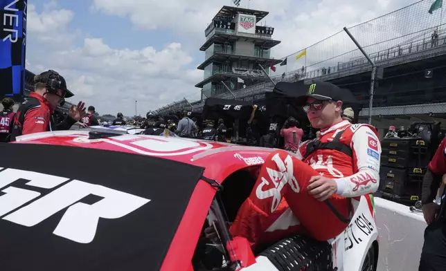 Ty Gibbs climbs into his car before a practice session for the NASCAR Cup Series auto race at Indianapolis Motor Speedway, Saturday, July 26, 2025, in Indianapolis. (AP Photo/Darron Cummings)