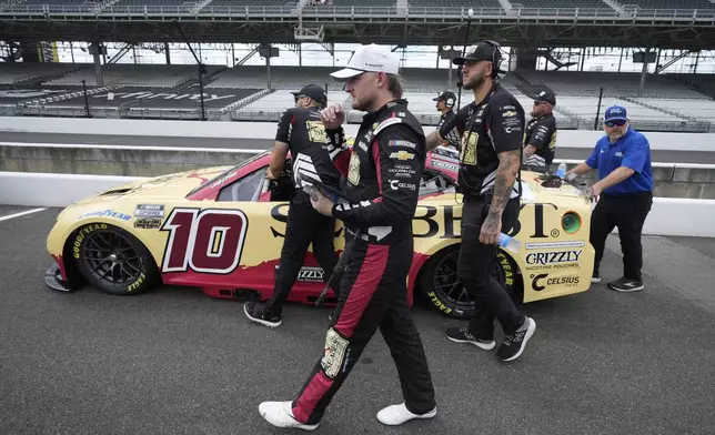 Ty Dillon walks with his car during qualifications for the NASCAR Cup Series auto race at Indianapolis Motor Speedway, Saturday, July 26, 2025, in Indianapolis. (AP Photo/Darron Cummings)