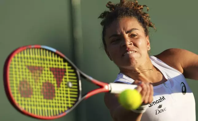Jasmine Paolini of Italy returns to Russia's Kamilla Rakhimova during their second round women's singles match at the Wimbledon Tennis Championships in London, Wednesday, July 2, 2025. (AP Photo/Joanna Chan)