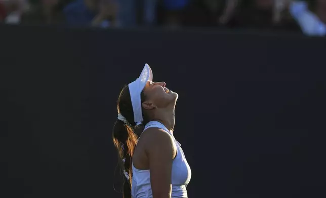 Russia's Kamilla Rakhimova reacts after beating Jasmine Paolini of Italy in a second round women's singles match at the Wimbledon Tennis Championships in London, Wednesday, July 2, 2025. (AP Photo/Joanna Chan)