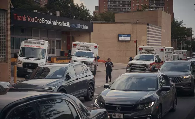 Ambulances are parked outside Brookdale University Hospital and Medical Center on Tuesday, July 1, 2025, in the Brooklyn borough of New York. (AP Photo/Andres Kudacki)