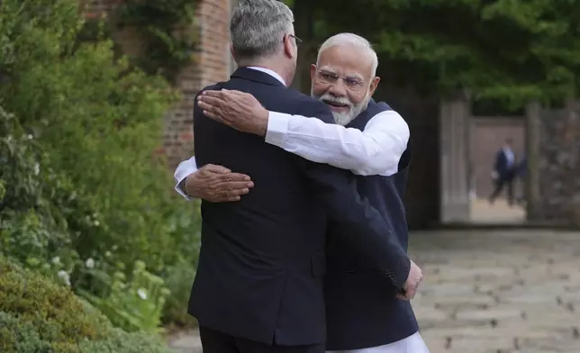 Indian Prime Minister Narendra Modi hugs Britain's Prime Minister Keir Starmer as he arrives at Chequers near Aylesbury, England, Thursday, July 24, 2025.(AP Photo/Kin Cheung, Pool)