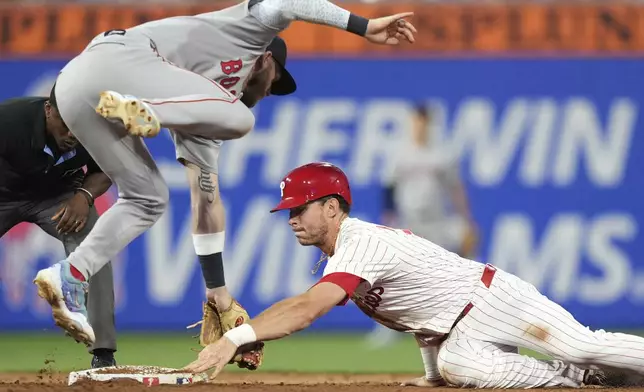 Philadelphia Phillies' Max Kepler, right, steals second base past Boston Red Sox shortstop Trevor Story during the sixth inning of a baseball game Tuesday, July 22, 2025, in Philadelphia. (AP Photo/Matt Slocum)