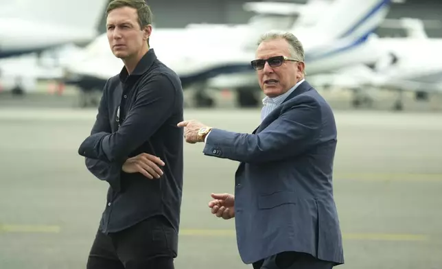 White House special envoy Steve Witkoff, right, and Jared Kushner wait for the arrival of President Donald Trump at Teterboro Airport in Teterboro, N.J., en route to attend the Club World Cup final soccer match, Sunday, July 13, 2025. (AP Photo/Jacquelyn Martin)