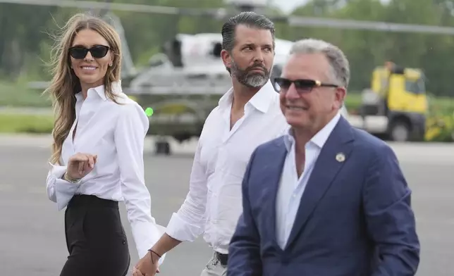 White House special envoy Steve Witkoff, from right, Donald Trump Jr., and Bettina Anderson watch as President Donald Trump arrives at Teterboro Airport in Teterboro, N.J., en route to attend the Club World Cup final soccer match, Sunday, July 13, 2025. (AP Photo/Jacquelyn Martin)