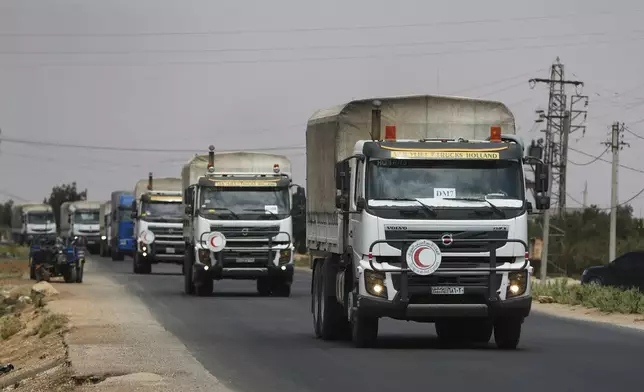 A convoy of vehicles loaded with food and other aid is en route to Sweida on the international highway in rural Daraa province, Syria, Sunday, July 20, 2025, heading to the city of Busra al-Sham. (AP Photo/Omar Sanadiki)