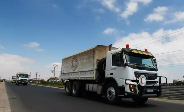A convoy of vehicles loaded with food and other aid is en route to Sweida on the international highway in rural Daraa province, Syria, Sunday, July 20, 2025, heading to the city of Busra al-Sham. (AP Photo/Omar Sanadiki)