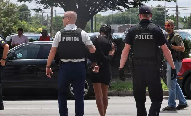 In this photo provided by WHAS-11 News, a protestor is seen detained by police outside the federal courthouse where ex-Kentucky police officer Brett Hankison, convicted of using excessive force during the deadly Breonna Taylor raid, is taking place, Monday, July 21, 2025, in Louisville, Ky. (Alyssa Newton/WHAS-11 News via AP)