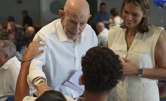 Harold Terens, a World War II veteran who fought in D-Day, greets friends at his 102 birthday party Saturday, July 26, 2025, in Delray Beach, Fla. (AP Photo/Marta Lavandier)