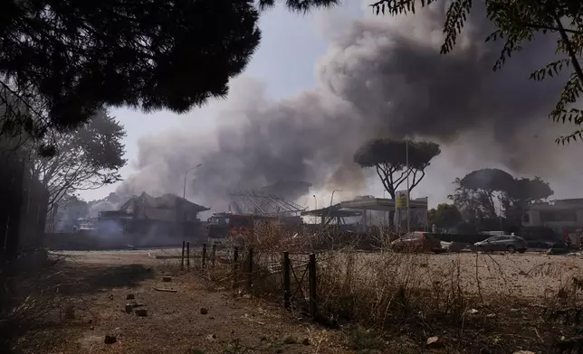 Smoke rises after a gas station exploded on the outskirts of Rome, Friday, July 4, 2025. (Cecilia Fabiano/LaPresse via AP)