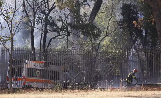Emergency services work as smoke rises after a gas station exploded on the outskirts of Rome, Friday, July 4, 2025. (Cecilia Fabiano/LaPresse via AP)