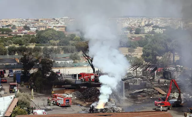 Smoke rises after a gas station exploded on the outskirts of Rome, Friday, July 4, 2025. (Cecilia Fabiano/LaPresse via AP)