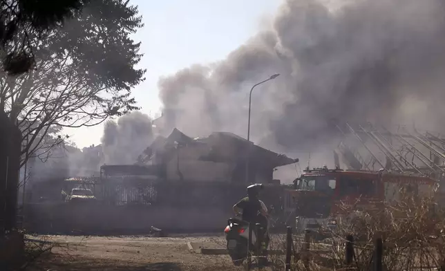 Smoke rises after a gas station exploded on the outskirts of Rome, Friday, July 4, 2025. (Cecilia Fabiano/LaPresse via AP)