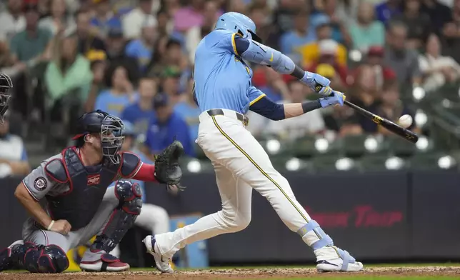 Milwaukee Brewers' Christian Yelich hits a two-run home run during the third inning of a baseball game against the Washington Nationals, Friday, July 11, 2025, in Milwaukee. (AP Photo/Aaron Gash)