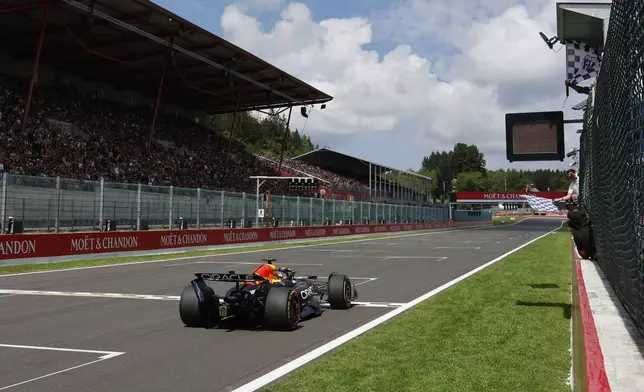 The checkered flag goes out as Red Bull driver Max Verstappen of the Netherlands crosses the finish line to take first place during the sprint race ahead of the Formula One Grand Prix at the Spa-Francorchamps racetrack in Spa, Belgium, Saturday, July 26, 2025. (Stephanie Lecocq, Pool Photo via AP)
