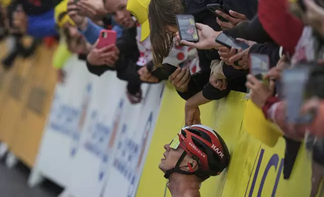 Cycling fans take images of Netherlands' Thymen Arensman after he crossed the finish line to win the nineteenth stage of the Tour de France cycling race over 93.1 kilometers (57.85 miles) with start in Albertville and finish in La Plagne, France, Friday, July 25, 2025. (AP Photo/Thibault Camus)