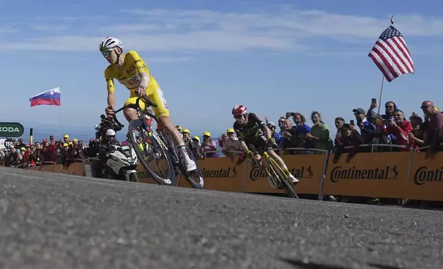 Slovenia's Tadej Pogacar, wearing the overall leader's yellow jersey, and Denmark's Jonas Vingegaard sprint towards the finish line of the sixteenth stage of the Tour de France cycling race over 171.5 kilometers (106.6 miles) with start in Montpellier and finish on the Mont Ventoux, France, Tuesday, July 22, 2025. (AP Photo/Thibault Camus)