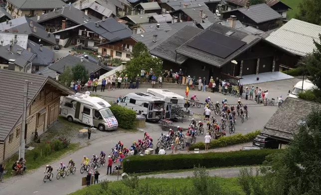 The pack with Slovenia's Tadej Pogacar, wearing the overall leader's yellow jersey, climbs Col du Pre during the nineteenth stage of the Tour de France cycling race over 93.1 kilometers (57.85 miles) with start in Albertville and finish in La Plagne, France, Friday, July 25, 2025. (AP Photo/Mosa'ab Elshamy)
