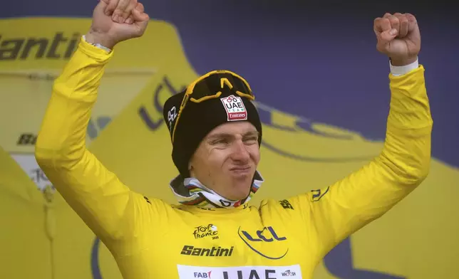 Slovenia's Tadej Pogacar, wearing the overall leader's yellow jersey, celebrates on the podium after the eighteenth stage of the Tour de France cycling race over 171.5 kilometers (106.6 miles) with start in Vif and finish in Courchevel Col de la Loze, France, Thursday, July 24, 2025. (AP Photo/Mosa'ab Elshamy)