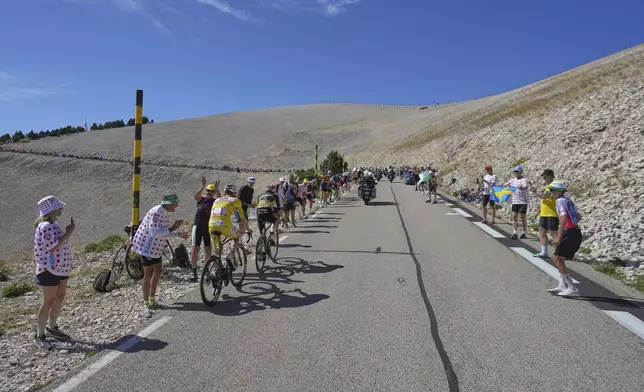 Slovenia's Tadej Pogacar, wearing the overall leader's yellow jersey, follows Denmark's Jonas Vingegaard as they climb Mont Ventoux during the sixteenth stage of the Tour de France cycling race over 171.5 kilometers (106.6 miles) with start in Montpellier and finish on the Mont Ventoux, France, Tuesday, July 22, 2025. (AP Photo/Thibault Camus)