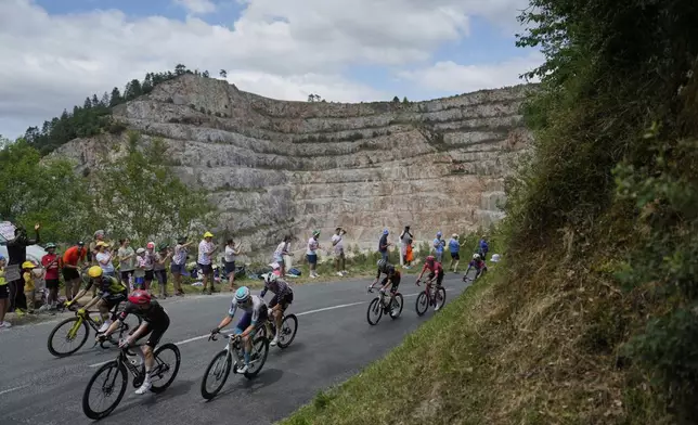 The breakaway group with Australia's Michael Storer, front, Belgium's Victor Campenaerts, yellow helmet, Slovenia's Matej Mohoric, blue helmet, Quinn Simmons of the U.S., wearing the national champion's jersey of the U.S.A., Belgium's Tim Wellens, third from right, Neilson Powless of the U.S., second right, and Kazakhstan's Alexey Lutsenko, half visible in the corner, ride during the fifteenth stage of the Tour de France cycling race over 169.3 kilometers (105.2 miles) with start in Muret and finish in Carcassone, France, Sunday, July 20, 2025. (AP Photo/Mosa'ab Elshamy)