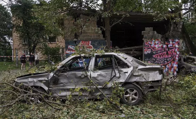 A car is seen damaged after a Russian strike in Kyiv, Ukraine, on Thursday, July 31, 2025. (AP Photo/Evgeniy Maloletka)