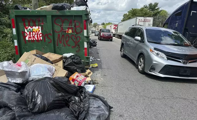 Trash piles up around dumpsters in Philadelphia as thousands of city workers remained on strike Monday, July 7, 2025. (AP Photo/Tassanee Vejpongsa)