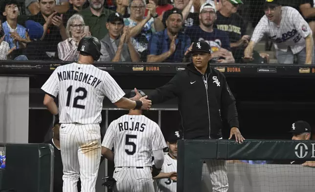 Chicago White Sox manager Will Venable, front right, celebrates with Colson Montgomery (12) after Montgomery scored on a Mike Tauchman single during the seventh inning of a baseball game against the Toronto Blue Jays, Monday, July 7, 2025, in Chicago. (AP Photo/Paul Beaty)