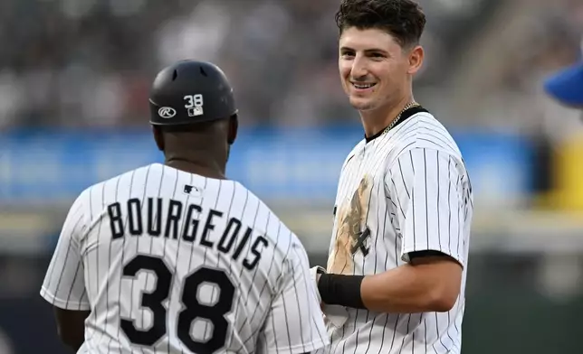 Chicago White Sox's Colson Montgomery, right, jokes with first base coach Jason Bourgeois (38) after flying out during the fourth inning of a baseball game against the Toronto Blue Jays, Monday, July 7, 2025, in Chicago. (AP Photo/Paul Beaty)