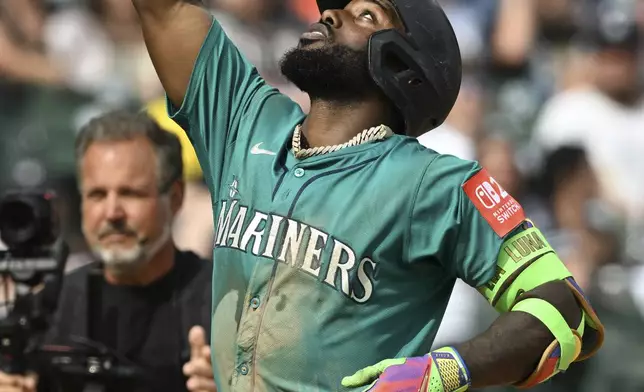 Seattle Mariners Randy Arozarena (56) celebrates as he rounds the bases after hitting a two-run home run against the Detroit Tigers in the eighth inning of a baseball game, Saturday, July 12, 2025, in Detroit. (AP Photo/Lon Horwedel)