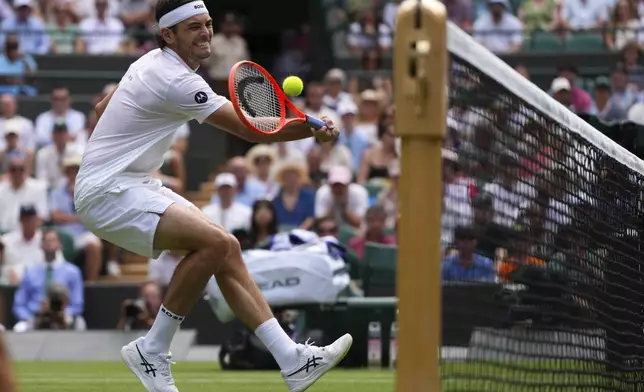Taylor Fritz of the U.S. returns the ball to Giovanni Mpetshi Perricard of France during their first round men's singles match at the Wimbledon Tennis Championships in London, Tuesday, July 1, 2025.(AP Photo/Kirsty Wigglesworth)