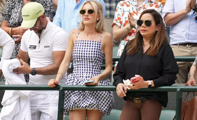 Taylor Fritz's girlfriend, Morgan Riddle, centre, watches Taylor Fritz of the U.S. playing the first round men's singles match against Giovanni Mpetshi Perricard of France at the Wimbledon Tennis Championships in London, Tuesday, July 1, 2025.(AP Photo/Kirsty Wigglesworth)