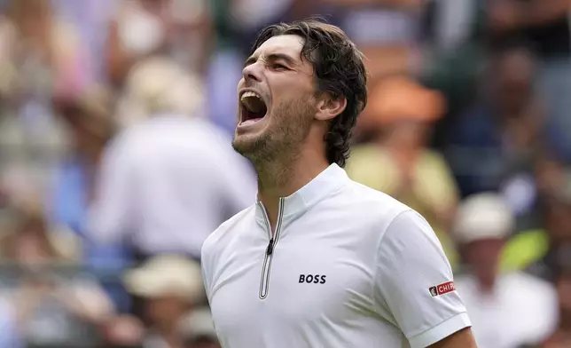 Taylor Fritz of the U.S. celebrates winning the first round men's singles match against Giovanni Mpetshi Perricard of France at the Wimbledon Tennis Championships in London, Tuesday, July 1, 2025.(AP Photo/Kirsty Wigglesworth)