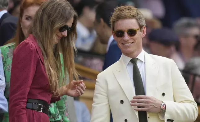 Actor Eddie Redmayne and his wife Hannah take their seats in the Royal Box on Centre Court on day one at the Wimbledon Tennis Championships in London, Monday, June 30, 2025. (AP Photo/Alastair Grant)