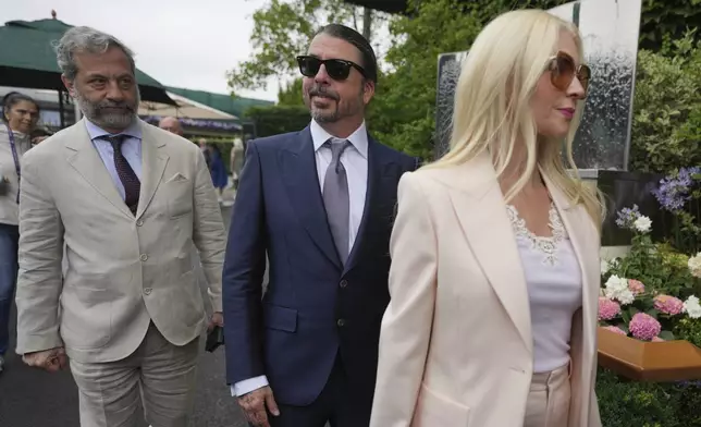 Musician Dave Grohl and his wife Jordyn arrive for day three at the Wimbledon Tennis Championships in London, Wednesday, July 2, 2025. (AP Photo/Alastair Grant)