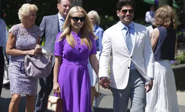 Singer, Katherine Jenkins and her husband Andrew Levitas arrive for day thirteen at the Wimbledon Tennis Championships in London, Saturday, July 12, 2025. (AP Photo/Dave Shopland)