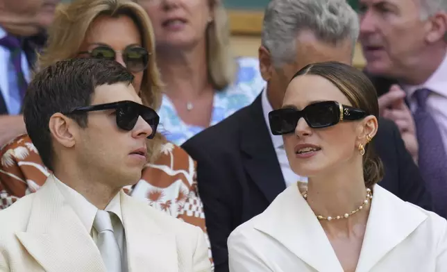 Actor Keira Knightley and James Righton sit in the Royal Box to watch Veronika Kudermetova of Russia and Elise Mertens of Belgium against Jelena Ostapenko of Latvia and Su-Weih Hsieh of Taiwan during the women's doubles final match at the Wimbledon Tennis Championships in London, Sunday, July 13, 2025.(AP Photo/Kirsty Wigglesworth)