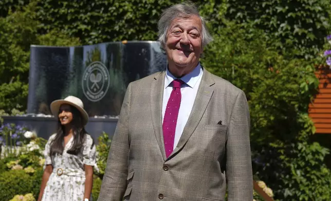 Actor, comedian and broadcaster Stephen Fry poses for a photo as he arrives for day eleven at the Wimbledon Tennis Championships in London, Thursday, July 10, 2025. (AP Photo/Joanna Chan)