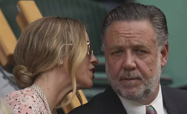 Actor Russell Crowe and Britney Theriot sits in the Royal Box on Centre Court on day two at the Wimbledon Tennis Championships in London, Tuesday, July 1, 2025. (AP Photo/Kin Cheung)