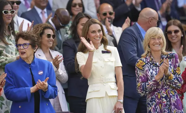 Britain's Kate, Princess of Wales, center, waves as she stands alongside tennis legend Billie Jean King in the Royal Box on Centre Court ahead of the women's singles final at the Wimbledon Tennis Championships in London, Saturday, July 12, 2025. (AP Photo/Kin Cheung)