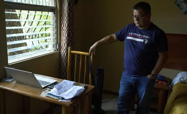 Jorge Beltran, a journalist who served in the Salvadoran military during the country's civil war and who left the country fearing political persecution, poses for a photo on Tuesday, July 22, 2025. (AP Photo/Moises Castillo)