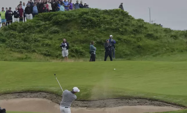 Rory McIlroy of Northern Ireland plays his second shot on12th hole from a bunker during the first round of the British Open golf championship at the Royal Portrush Golf Club, Northern Ireland, Thursday, July 17, 2025. (AP Photo/Jon Super)