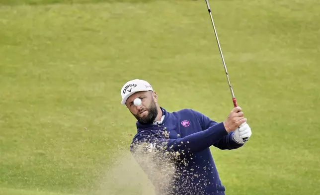 Jon Rahm of Spain plays out of a bunker on the 7th green during a practice round for the British Open golf championship at the Royal Portrush Golf Club, Northern Ireland, Tuesday, July 15, 2025. (AP Photo/Francisco Seco)