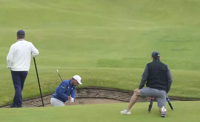 Bryson DeChambeau of the United States plays out of a bunker on the 9th hole during a practice round for the British Open golf championship at the Royal Portrush Golf Club, Northern Ireland, Tuesday, July 15, 2025. (AP Photo/Jon Super)